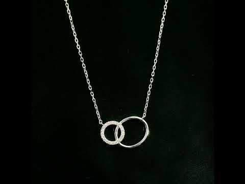 Interlocking circle diamond necklace in 18K white gold with one pavé diamond circle and one polished circle.