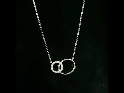 Interlocking circle diamond necklace in 18K white gold with one pavé diamond circle and one polished circle.