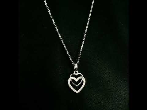 Diamond heart pendant in 18K white gold featuring overlapping open hearts with round brilliant diamond detailing.
