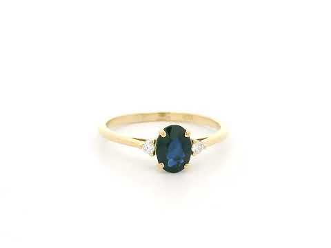 Oval blue sapphire and diamond three stone ring in 18K yellow gold