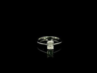 18K white gold solitaire ring featuring a 0.90 carat IGI certified natural emerald cut diamond with VS2 clarity and D colour in a classic four-prong setting.