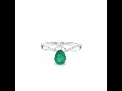 Pear shaped natural emerald and diamond ring in 18K white gold with diamond accented sculpted shoulders