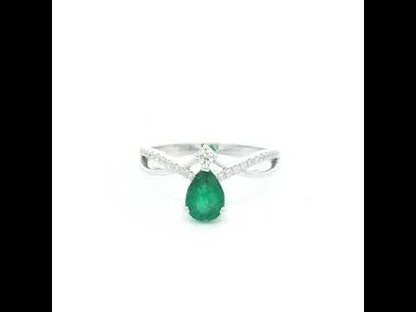 Pear shaped natural emerald and diamond ring in 18K white gold with diamond accented sculpted shoulders