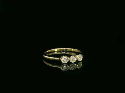 18K yellow gold three-stone natural diamond ring with minimalist bezel setting by Emirates Diamonds