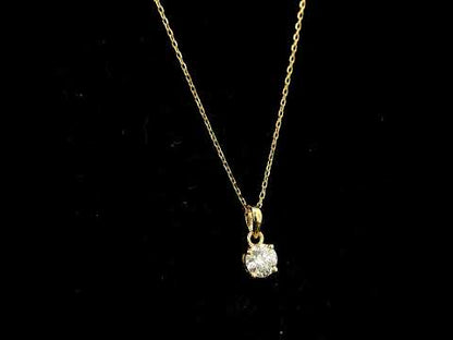 18K yellow gold solitaire pendant featuring a 0.70 carat GIA certified round brilliant natural diamond in a classic four-prong setting, supplied without a chain.