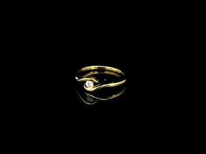 Solitaire diamond twist ring in 18K yellow gold featuring a 0.10 carat natural diamond
