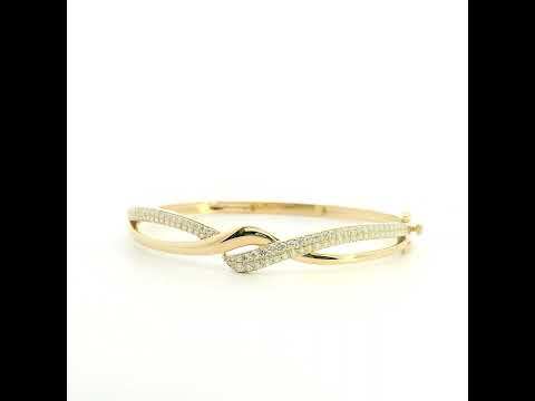 18K yellow gold diamond crossover bangle with intertwined polished and pavé diamond-set sections.
