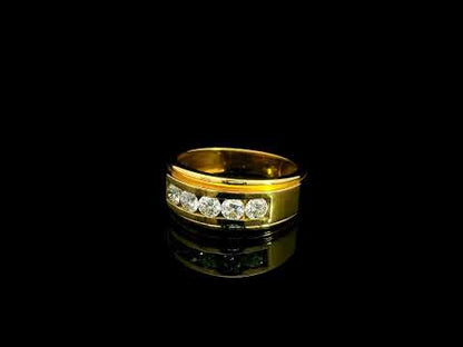 Yellow gold diamond band ring with channel set round diamonds and broad polished gold edges