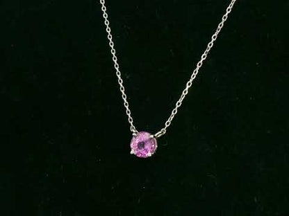 18K white gold pink sapphire solitaire necklace featuring a 0.61 carat round pink sapphire pendant by Emirates Diamonds