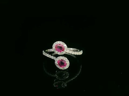 18K white gold ruby and diamond bypass ring with dual oval rubies and diamond halos by Emirates Diamonds