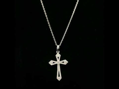 Diamond cross pendant in 18K white gold with round diamonds, an openwork design and distinctive pointed ends.