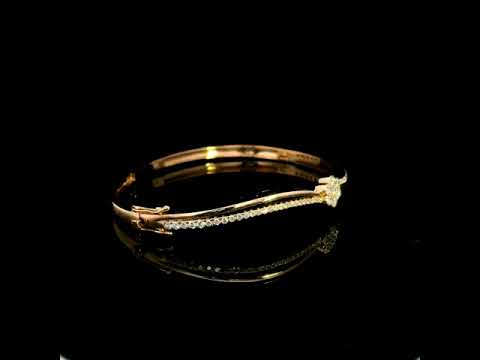 18K rose gold double row diamond bangle with flowing wave design, pavé diamond detailing and central floral diamond motif.