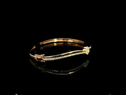 18K rose gold double row diamond bangle with flowing wave design, pavé diamond detailing and central floral diamond motif.