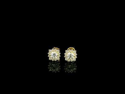 Diamond halo stud earrings in 18K yellow gold with round centre diamonds surrounded by smaller round diamonds.