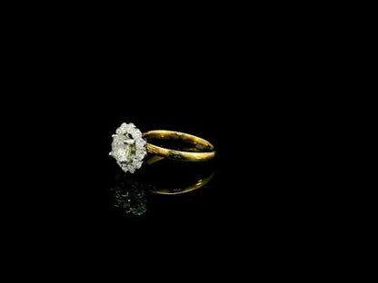Natural diamond halo engagement ring in solid 18K yellow gold featuring a 0.70 carat IGI certified round brilliant centre diamond surrounded by 0.51 carat natural diamonds.