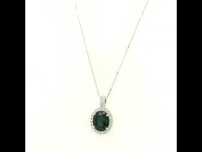 Oval sapphire and diamond halo pendant in 18K white gold with diamond-set bail