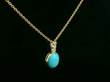 18K yellow gold pendant with 2.46ct oval turquoise and 0.14ct diamond accents.