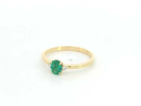 Dainty oval emerald and diamond ring in 18K yellow gold by Emirates Diamonds
