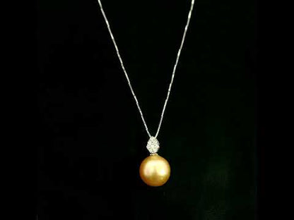 South Sea golden pearl and diamond pendant in 18K white gold featuring a 10 x 13 mm golden pearl and pear-shaped diamond detail.