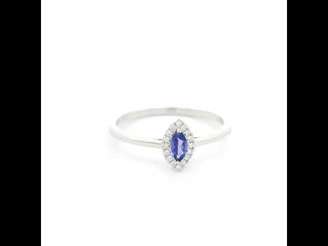 Dainty marquise tanzanite and diamond halo ring in 18K white gold with a slim polished band.