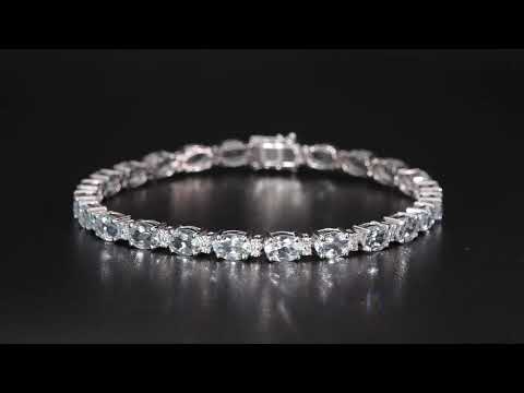 Aquamarine tennis bracelet in 18K white gold featuring oval blue aquamarine gemstones and sparkling diamond accents.
