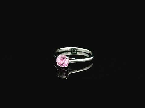 18K white gold pink sapphire solitaire ring featuring a 0.91 carat round pink sapphire in a classic four-prong setting