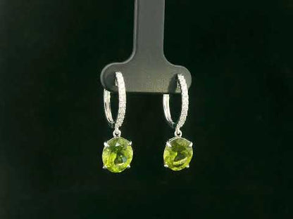 Peridot and diamond drop hoop earrings in 18K white gold with oval-cut peridots totaling 4.86 carats by Emirates Diamonds