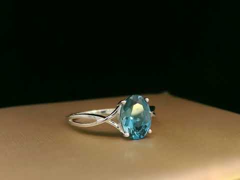 18K white gold bypass ring with 1.86 carat oval London Blue Topaz, elegant statement design