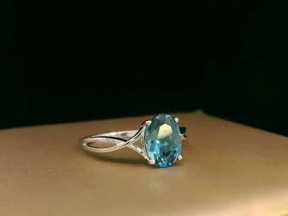18K white gold bypass ring with 1.86 carat oval London Blue Topaz, elegant statement design