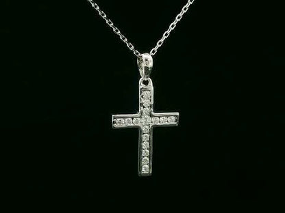 18K gold cross pendant with 0.20 carat round diamonds, religious charm on black background

