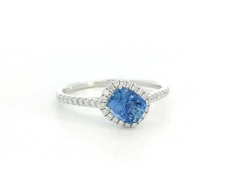18K white gold ring with an emerald-cut blue sapphire, diamond halo, and pavé diamond band

