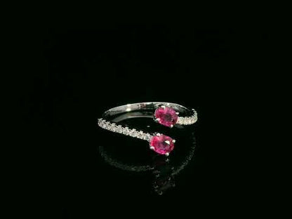 18K white gold open bypass ring with oval ruby gemstones and pavé diamond accents – fine ruby and diamond jewelry by Emirates Diamonds.