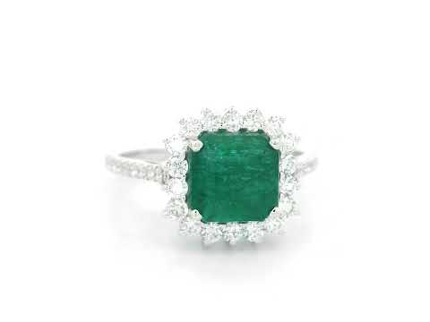 Emerald and diamond halo ring in 18K white gold featuring a 2.12 carat emerald and pavé diamond band by Emirates Diamonds