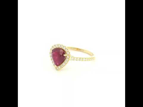 Pear shaped ruby and diamond halo ring in 18K yellow gold with diamond-set shoulders