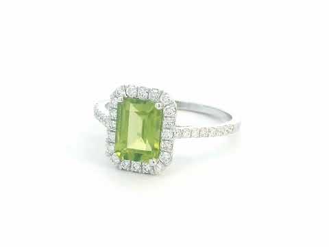 18K white gold emerald-cut Peridot ring with 0.35ct diamond halo, featuring 1.58ct Peridot centerpiece.