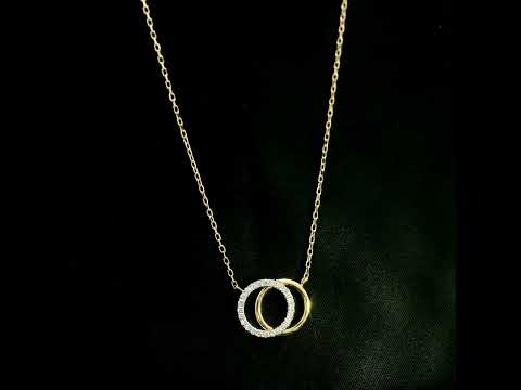 Interlocking diamond circle necklace in 18K yellow gold with one diamond-set circle and one polished gold circle.