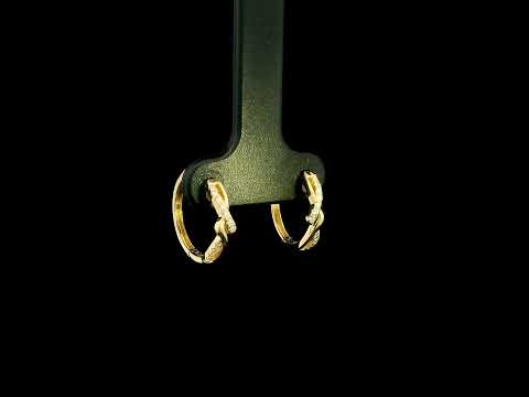 Diamond twist hoop earrings in 18K yellow gold with intertwined polished gold and round brilliant diamond details.