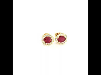 18K yellow gold natural ruby diamond halo stud earrings featuring round rubies surrounded by brilliant natural diamonds.