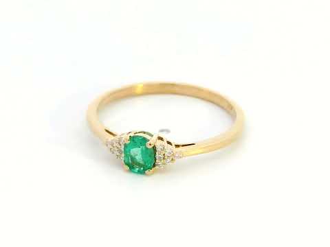 Petite 18K gold ring featuring a 0.30-carat emerald center stone, accented by 0.06-carat diamonds. Perfect for stacking or wearing alone.