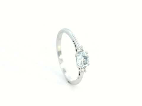 Minimalist oval aquamarine and diamond ring in 18K gold – March birthstone ring.