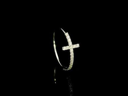 Diamond cross ring in 18K white gold featuring round brilliant diamonds set across the cross and along the slender band.