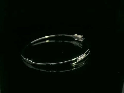 0.25 carat diamond bypass bangle in 18K white gold by Emirates Diamonds featuring floating round brilliant diamonds.