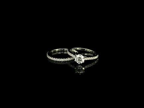 Round diamond bridal set in 18K white gold with GIA certified natural diamond engagement ring and matching diamond wedding band.