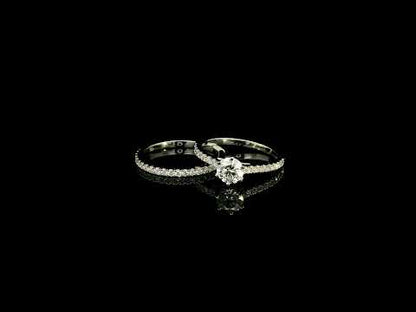 Round diamond bridal set in 18K white gold with GIA certified natural diamond engagement ring and matching diamond wedding band.