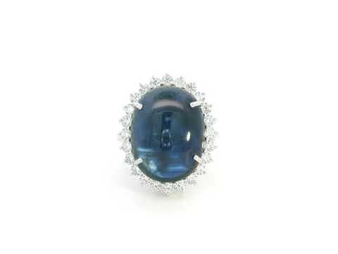 18K white gold oval blue sapphire ring with diamond halo, high-carat sapphire statement ring by Emirates Diamonds