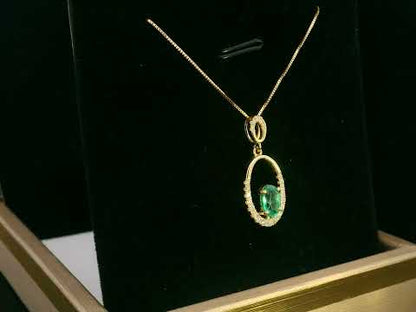 18K gold emerald and diamond oval pendant featuring a 0.42ct green emerald and 0.15ct diamonds, designed for layering—pair with various chain styles for a trendy, personalized look.