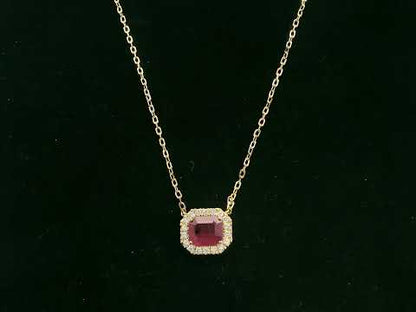 18K yellow gold ruby necklace with cushion-cut ruby and diamond halo by Emirates Diamonds