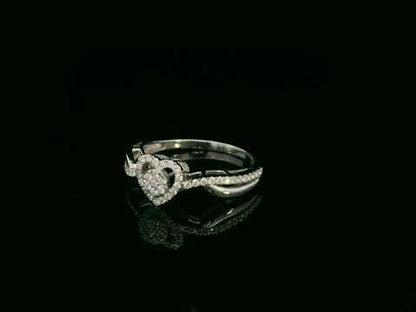 Heart-shaped diamond cluster ring in 18K white gold with pavé diamond band by Emirates Diamonds.