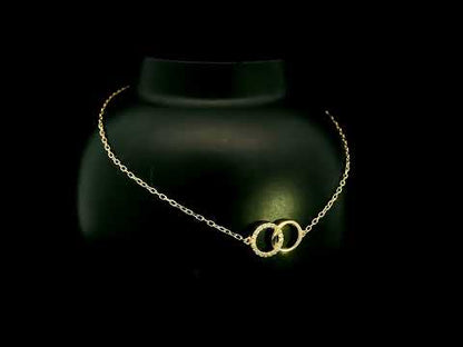 18K yellow gold diamond circle bracelet with two interlocking rings, featuring one polished gold circle and one round diamond-set circle
