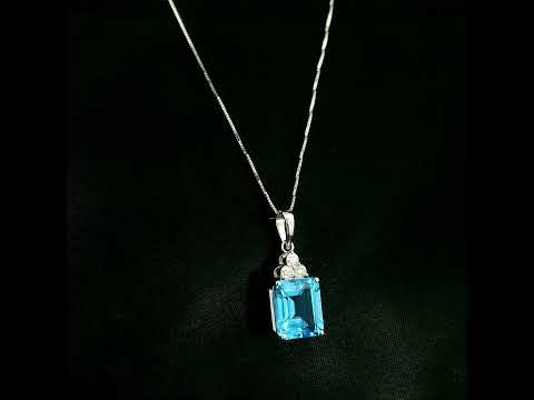 Swiss blue topaz pendant with emerald-cut blue topaz and diamond accents in 18K white gold.